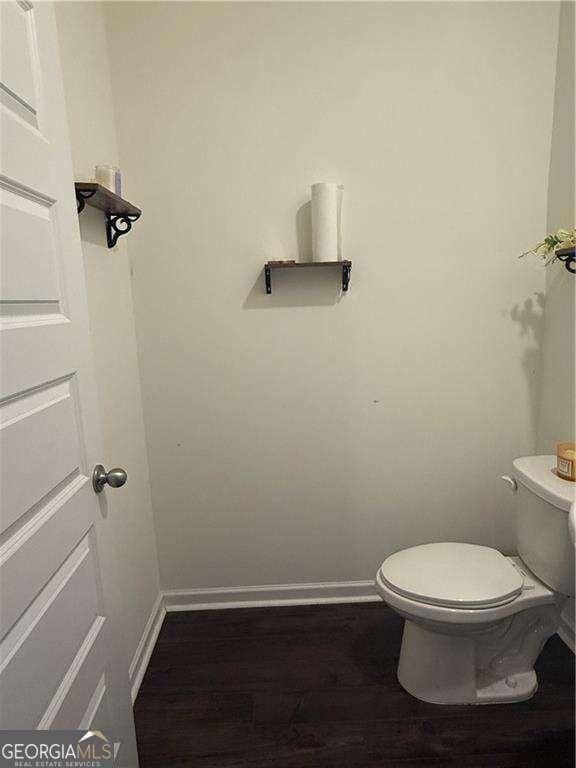 184 Grafton St, Hampton, GA 30228 - bathroom featuring toilet, wood finished floors, and baseboards