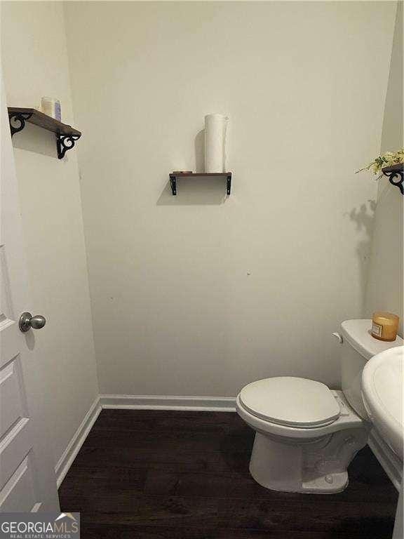 184 Grafton St, Hampton, GA 30228 - bathroom with toilet, wood finished floors, and baseboards
