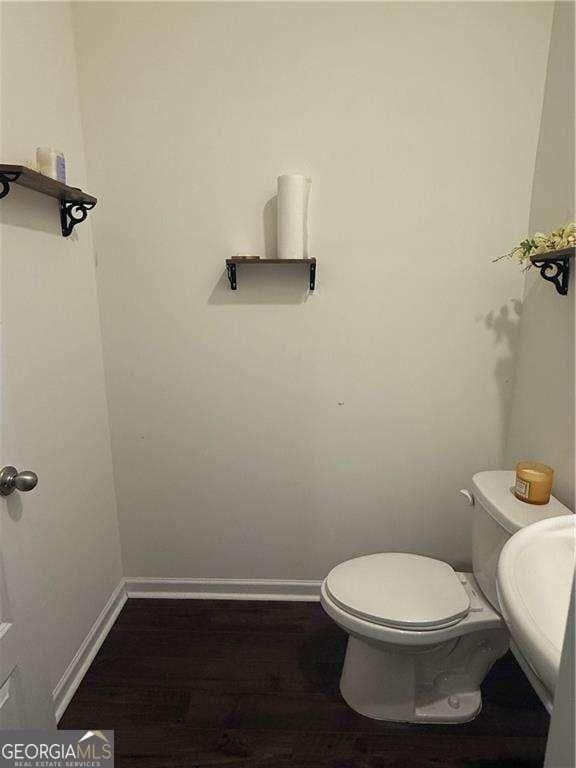 184 Grafton St, Hampton, GA 30228 - half bathroom with toilet, wood finished floors, and baseboards
