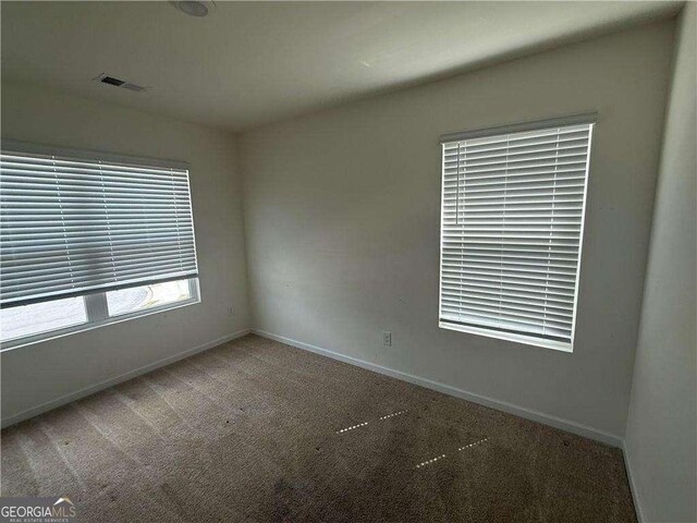 184 Grafton St, Hampton, GA 30228 - spare room with visible vents, baseboards, and carpet