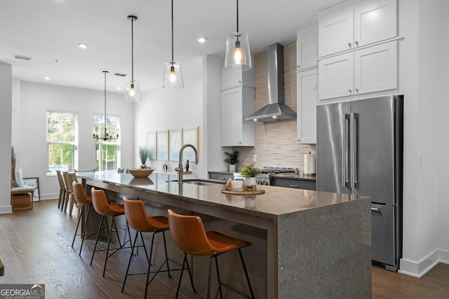 2614 Talley St, Decatur, GA 30030 - kitchen with a sink, high end fridge, wall chimney exhaust hood, an island with sink, and backsplash