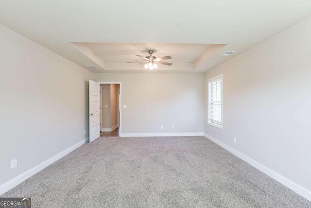 417 Flowery Branch Ct, Villa Rica, GA 30180 - carpeted empty room featuring a tray ceiling, baseboards, a ceiling fan, and visible vents