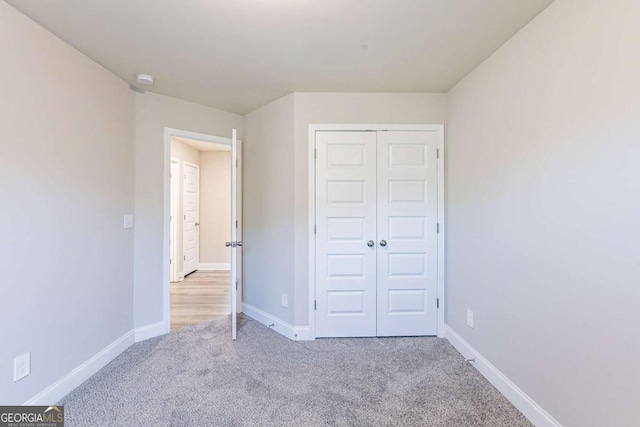 417 Flowery Branch Ct, Villa Rica, GA 30180 - unfurnished bedroom featuring a closet, baseboards, and carpet