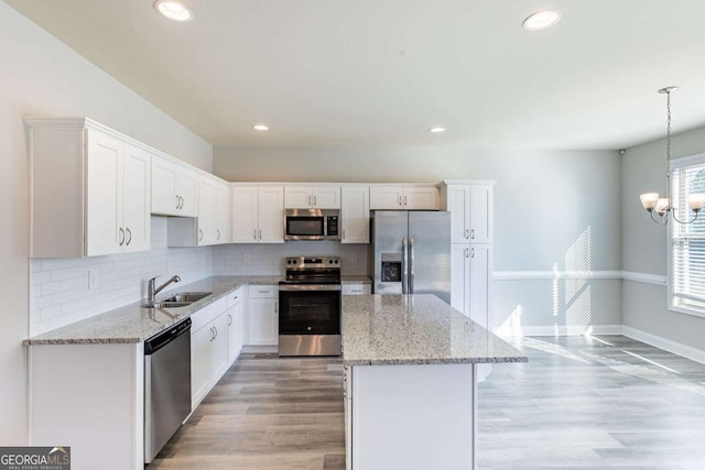 417 Flowery Branch Ct, Villa Rica, GA 30180 - kitchen featuring a center island, a sink, white cabinetry, and stainless steel appliances