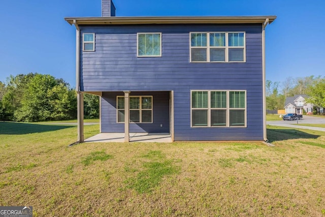 417 Flowery Branch Ct, Villa Rica, GA 30180 - rear view of property with a patio area, a lawn, and a chimney