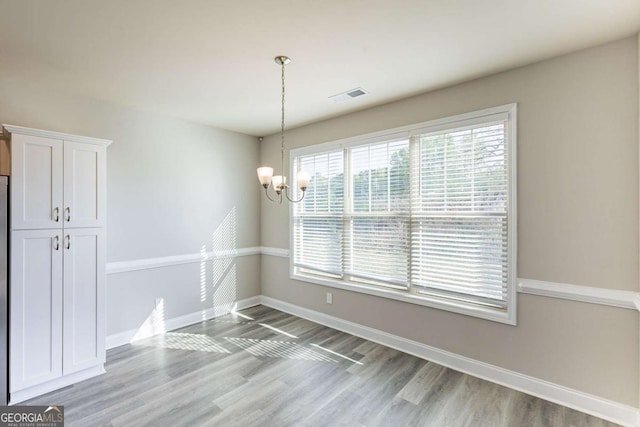 417 Flowery Branch Ct, Villa Rica, GA 30180 - unfurnished dining area featuring wood finished floors, an inviting chandelier, baseboards, and visible vents