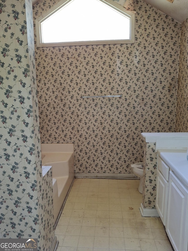 172 Willow Springs Ln, Stockbridge, GA 30281 - bathroom featuring wallpapered walls, a bath, vanity, and tile patterned floors