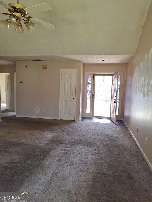 172 Willow Springs Ln, Stockbridge, GA 30281 - carpeted foyer with baseboards and ceiling fan