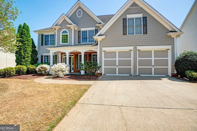 5177 Cabot Creek Dr, Buford, GA 30518 - view of front of house with covered porch, a garage, driveway, and a front lawn