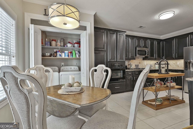 dining space with light tile patterned floors, independent washer and dryer, and crown molding