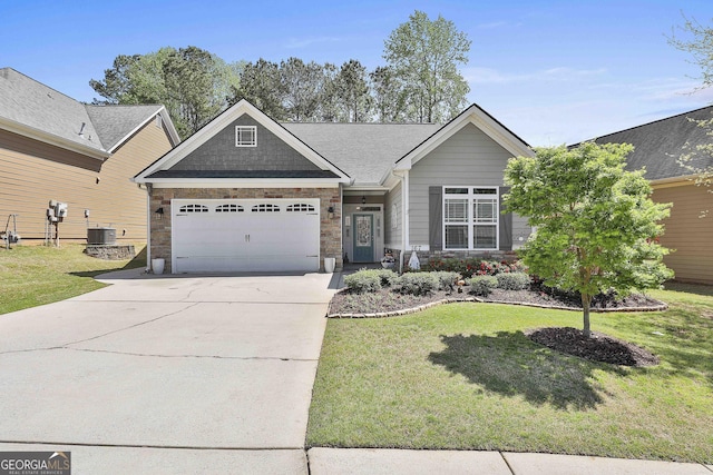 craftsman-style home with a front yard, an attached garage, stone siding, cooling unit, and concrete driveway