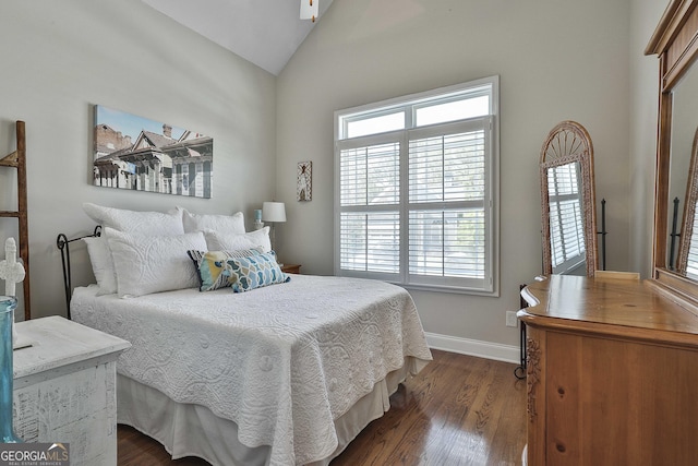 bedroom featuring dark wood-style flooring, baseboards, and lofted ceiling