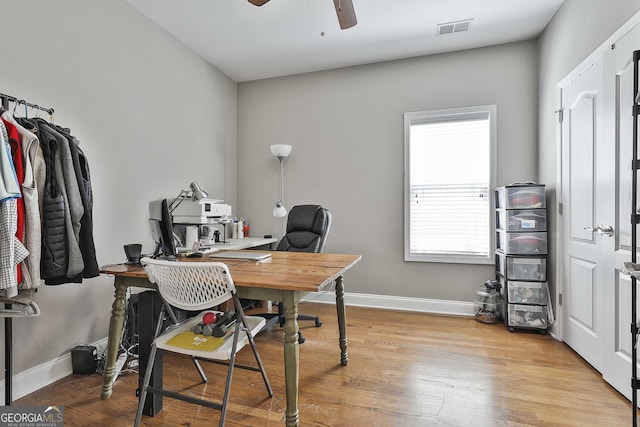 office with visible vents, ceiling fan, light wood-type flooring, and baseboards