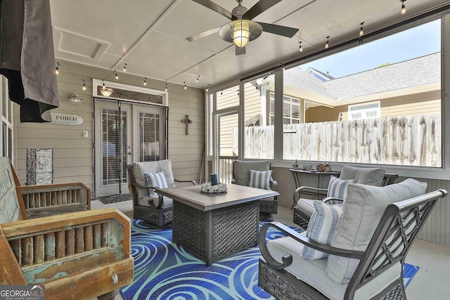 sunroom featuring track lighting, outdoor lounge area, and ceiling fan