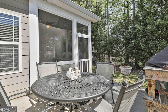 exterior space with outdoor dining space and a sunroom