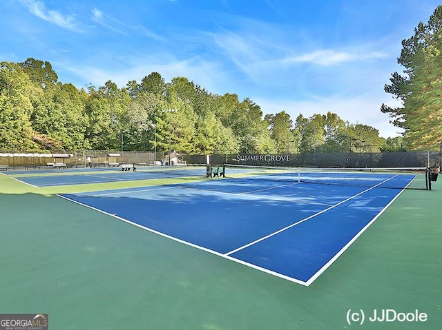 view of tennis court with fence
