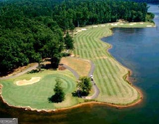 birds eye view of property with a forest view and a water view