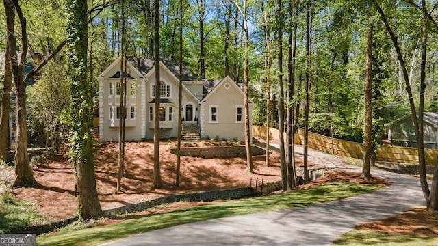 view of front of home featuring fence and stucco siding