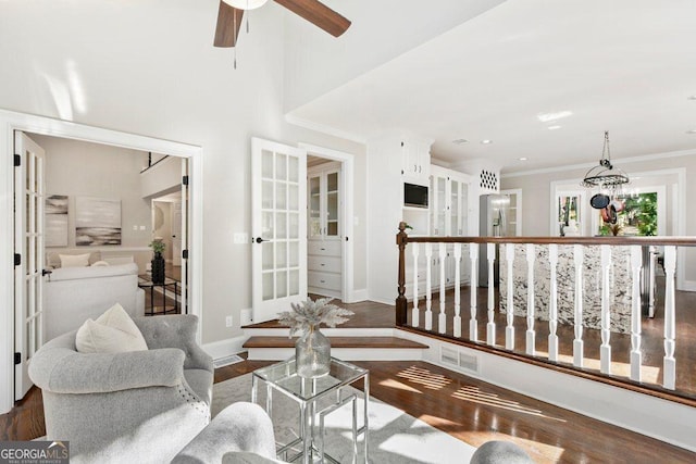 living room featuring wood finished floors, a ceiling fan, crown molding, french doors, and baseboards