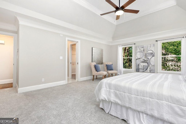bedroom with crown molding, carpet flooring, baseboards, a tray ceiling, and ceiling fan