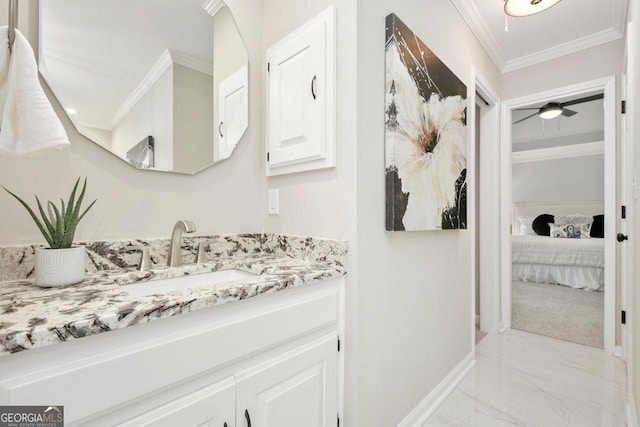 bathroom featuring marble look tile flooring, crown molding, vanity, baseboards, and a ceiling fan
