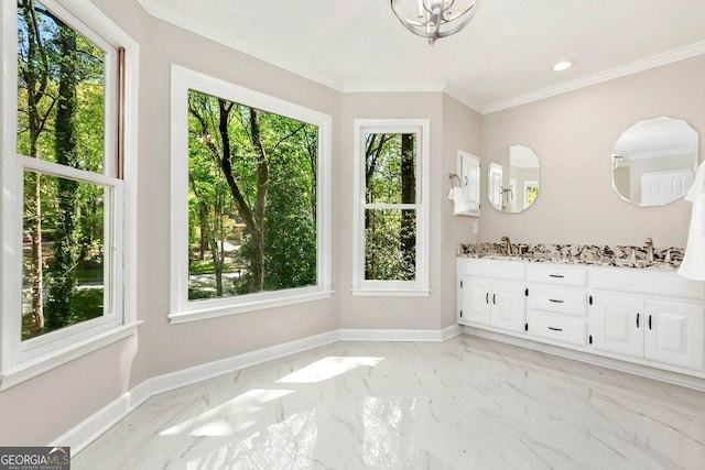 bathroom with plenty of natural light, marble finish floors, baseboards, and crown molding