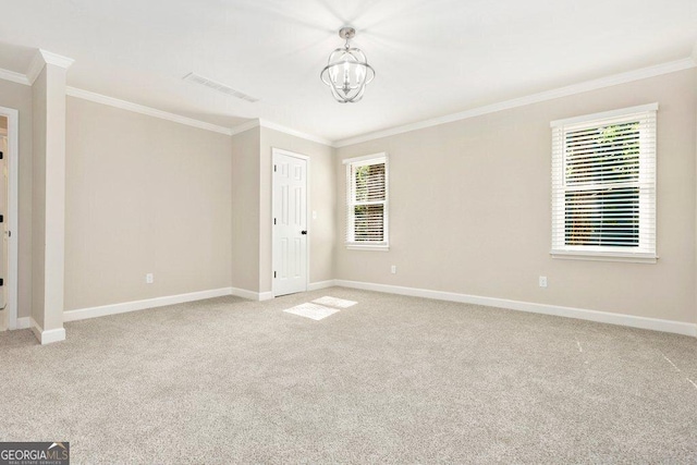 spare room with ornamental molding, light carpet, a chandelier, and baseboards