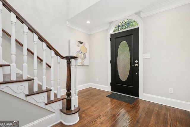 foyer entrance with wood finished floors, baseboards, stairs, ornamental molding, and recessed lighting