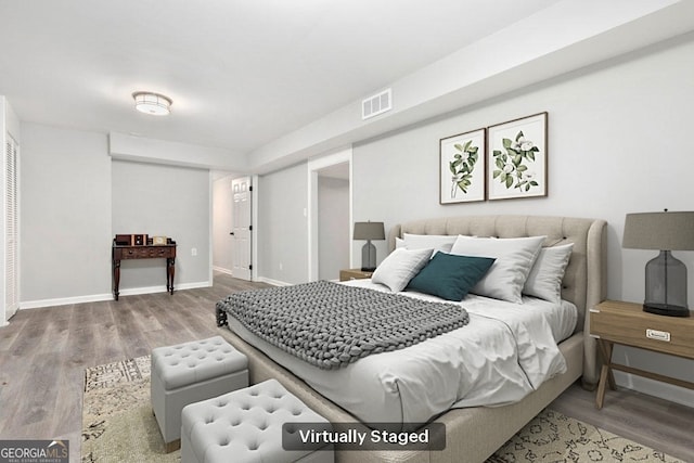 bedroom with wood finished floors and baseboards