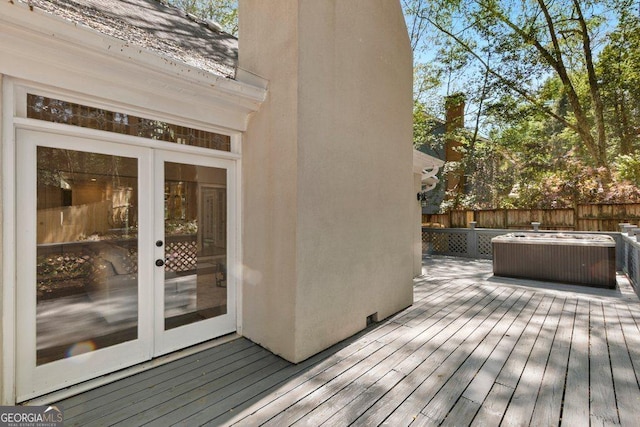 deck featuring french doors and fence