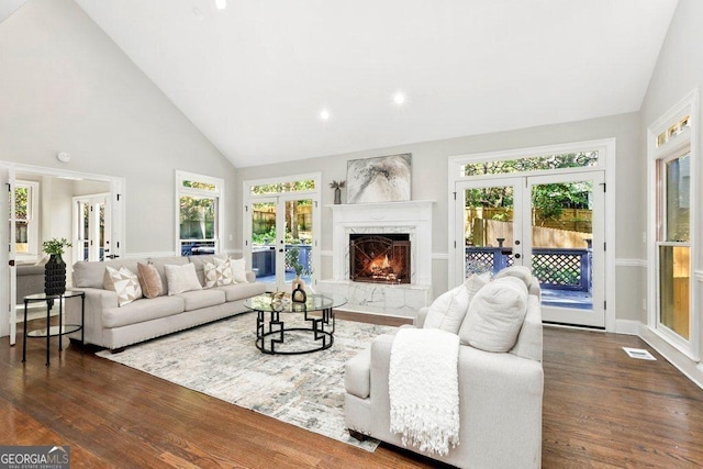 living room featuring french doors, dark wood finished floors, healthy amount of natural light, high vaulted ceiling, and recessed lighting