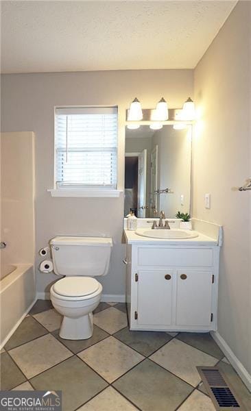 bathroom with vanity, visible vents, toilet, tile patterned floors, and baseboards