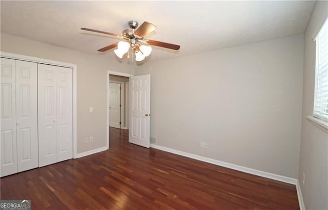 unfurnished bedroom with wood finished floors, ceiling fan, baseboards, and a closet