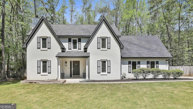 214 Windgate Ct, Peachtree City, GA 30269 - view of front facade with a shingled roof, a chimney, and brick siding