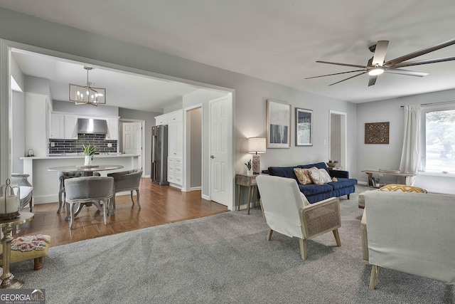214 Windgate Ct, Peachtree City, GA 30269 - living area with a chandelier, a ceiling fan, dark colored carpet, and dark wood finished floors