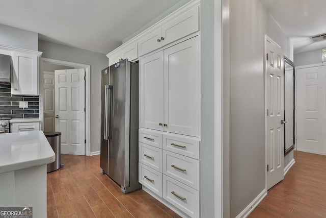 214 Windgate Ct, Peachtree City, GA 30269 - kitchen featuring high end refrigerator, white cabinetry, dark wood finished floors, and light countertops