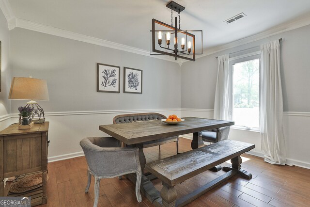 214 Windgate Ct, Peachtree City, GA 30269 - dining room with wood finished floors, crown molding, and a chandelier