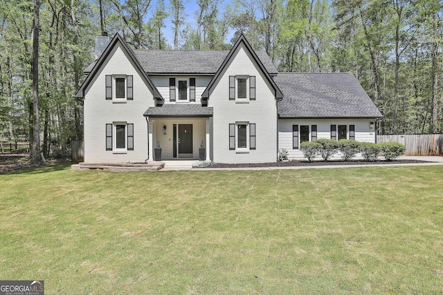 214 Windgate Ct, Peachtree City, GA 30269 - view of front of house with brick siding, a chimney, roof with shingles, and a porch