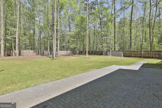 214 Windgate Ct, Peachtree City, GA 30269 - fenced backyard featuring a sport area, a patio area, and a forest view