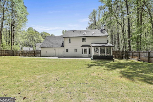 214 Windgate Ct, Peachtree City, GA 30269 - back of property with a sunroom, a chimney, a fenced backyard, a patio area, and roof with shingles