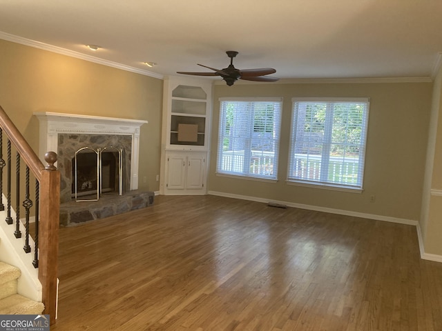 863 Fairwood Pointe NW, Acworth, GA 30101 - unfurnished living room with stairway, crown molding, a fireplace, and wood finished floors