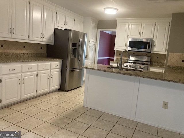 863 Fairwood Pointe NW, Acworth, GA 30101 - kitchen with stainless steel appliances, white cabinetry, decorative backsplash, and light tile patterned floors