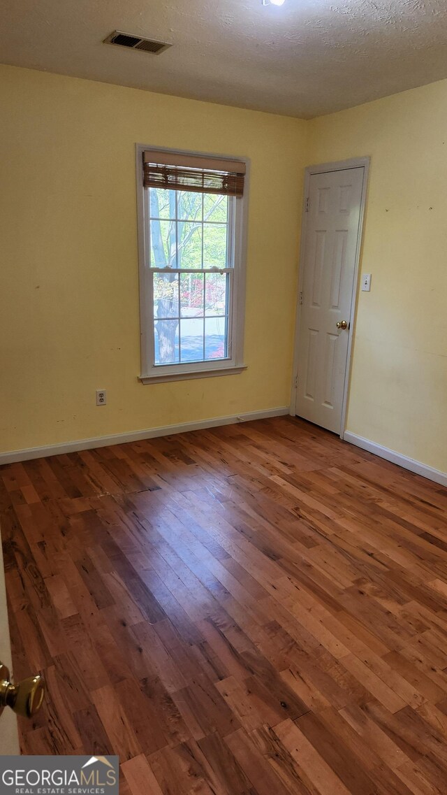 985 Lake Haven Ct, Roswell, GA 30076 - empty room with visible vents, baseboards, and wood-type flooring