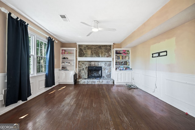 985 Lake Haven Ct, Roswell, GA 30076 - unfurnished living room with visible vents, a ceiling fan, a fireplace, a wainscoted wall, and hardwood / wood-style floors