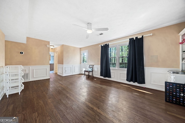 985 Lake Haven Ct, Roswell, GA 30076 - unfurnished living room with hardwood / wood-style flooring, visible vents, ceiling fan, and wainscoting