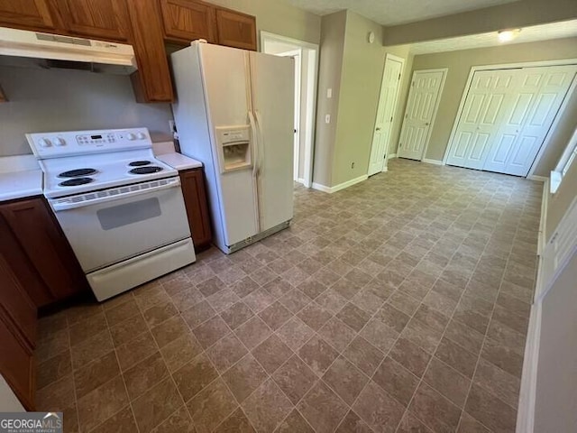 kitchen with baseboards, white appliances, brown cabinetry, light countertops, and under cabinet range hood