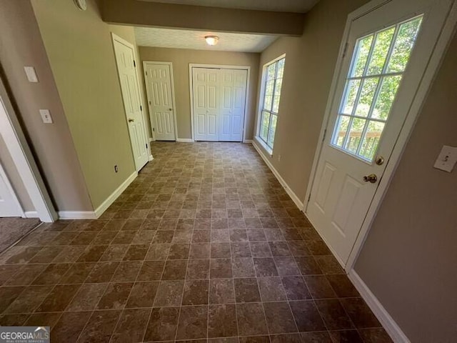 doorway to outside with baseboards