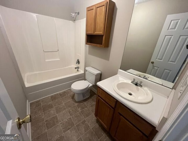 bathroom featuring toilet, vanity, and shower / tub combination