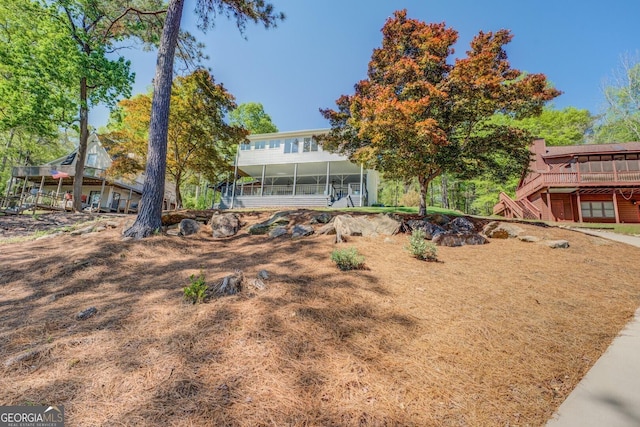 exterior space with a sunroom and a deck