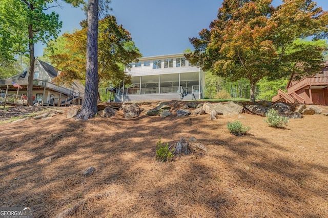 back of property featuring a sunroom
